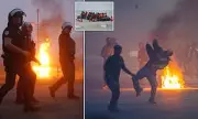 Chaos in Calais: Riot Police Clash with Migrants as Small Boat Heads to Britain