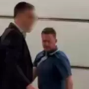 Tommy Robinson in Brawl: Far-Right Activist Punched by Elderly Man in Shocking Footage