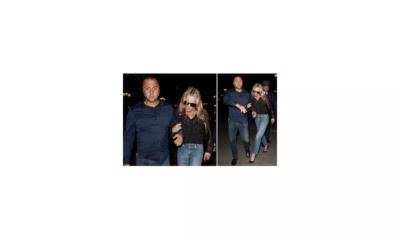 Kate Moss Shrouded in Mystery: Supermodel Clings to Bodyguard Behind Dark Glasses at Paris Fashion Week