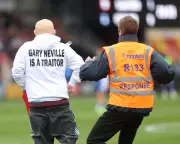 Pitch Invasion Halts League Two Clash in Anti-Gary Neville Protest