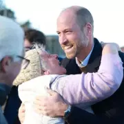 Prince William Embraced by Enthusiastic Fan During North Wales Coastal Visit