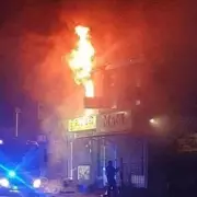 Major Fire Erupts at Salford Business Premises, Crews Battle Blaze