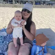 Mum sparks outrage after video shows baby 'alone' on beach during swim