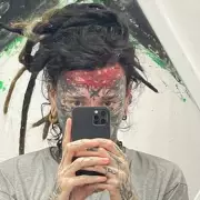Polish Tattoo Artist Endures Extreme Pain to Ink Own Forehead with Red Vine