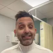 NHS Doctor Amir Khan's Lift Dance Mishap Sparks Fan Support