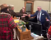 Wyoming Political Storm as Activist Hands Checks to Lawmakers on House Floor