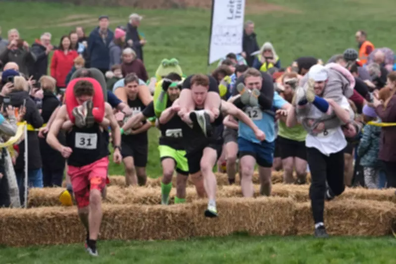 Couples Triumph in UK Wife Carrying Race Amid Muddy March Conditions
