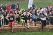 Couples Triumph in UK Wife Carrying Race Amid Muddy March Conditions