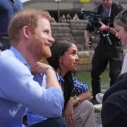 Prince Harry Dances with Young Girl Before Sailing Sydney Harbour with Meghan Markle