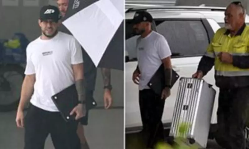 Billionaire Adrian Portelli flies out of Gold Coast with staff carrying his luggage