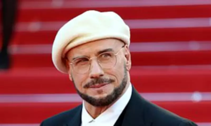 John Travolta's Bizarre Beret and Dyed Beard Stuns Fans at Cannes