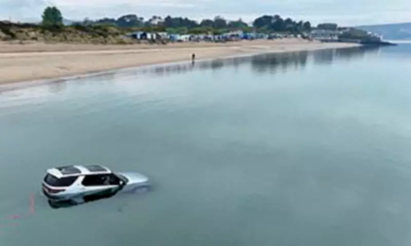 Luxury Land Rover Discovery Submerged by Tide on Welsh Beach