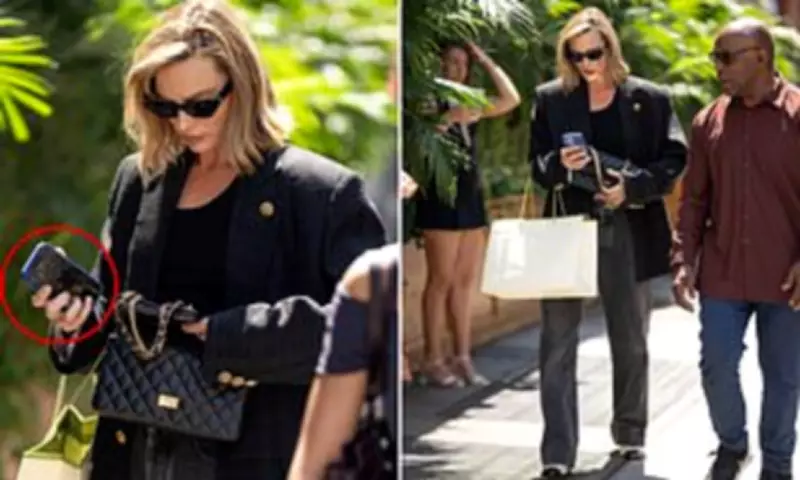 Margot Robbie Strolls NYC in Chanel, Shows Son Photo on Phone