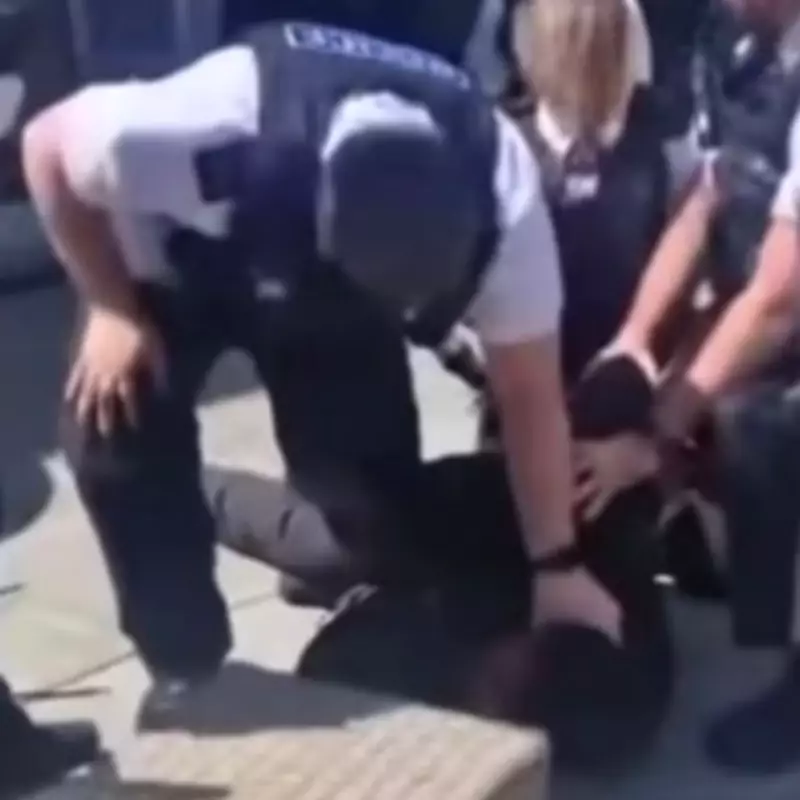 Woman shouts 'get off his neck' as Merseyside Police officers pin suspect during arrest