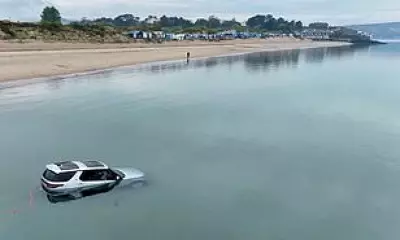 Luxury Land Rover Discovery Submerged by Tide on Welsh Beach