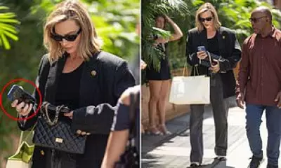 Margot Robbie Strolls NYC in Chanel, Shows Son Photo on Phone