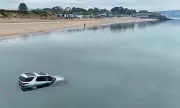 Luxury Land Rover Discovery Submerged by Tide on Welsh Beach