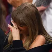 Taylor Swift Hides Face as Travis Kelce Chugs Beer at Basketball Game