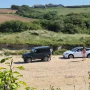 Tesla driver branded 'moron' after parking on Cornwall beach and swearing at locals