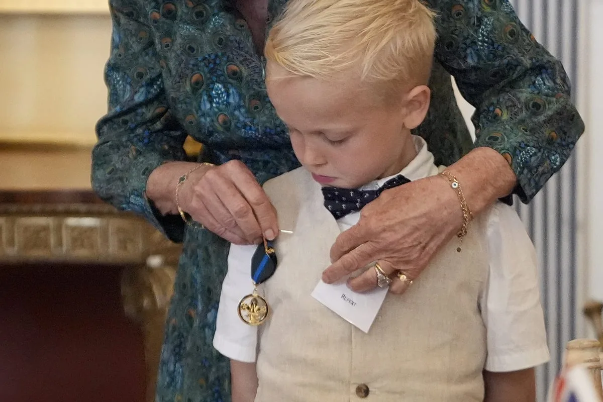 Seriously ill boy gets Queen Camilla to pin Scouts bravery medal