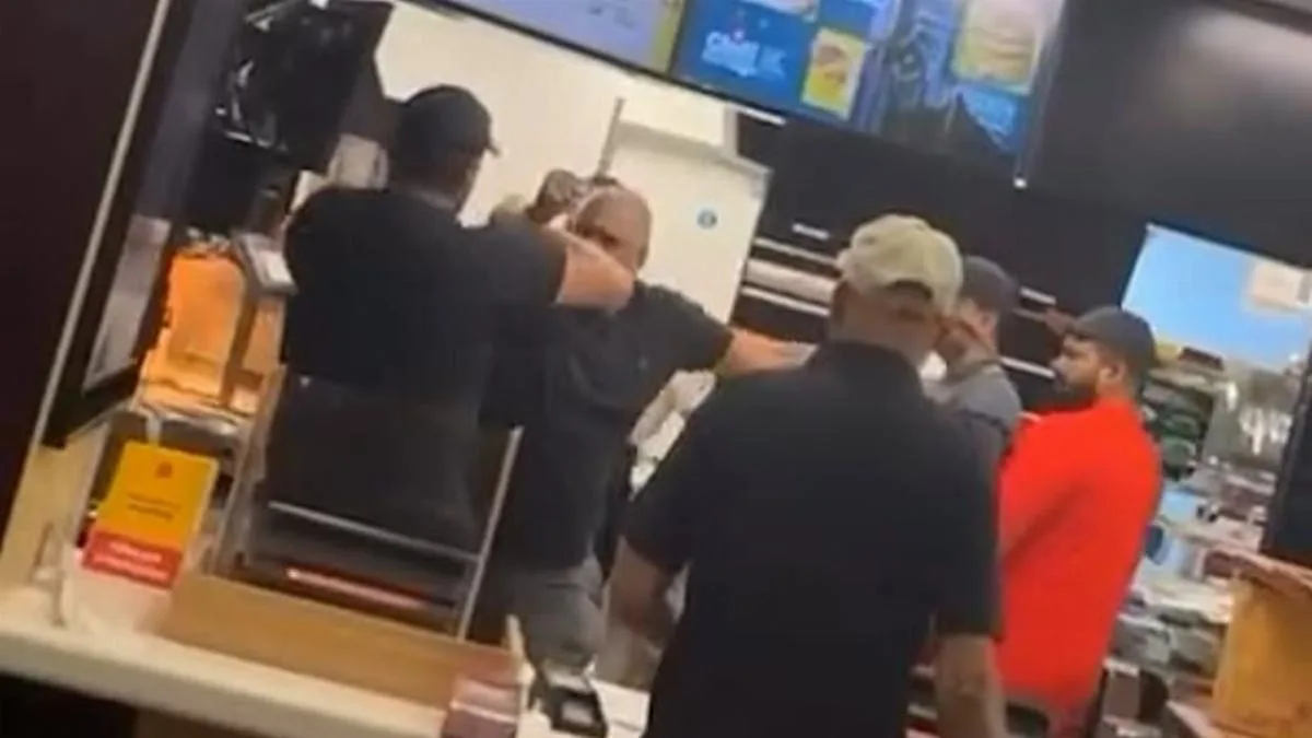 Moment McDonald's customer jumps counter and attacks staff in west London