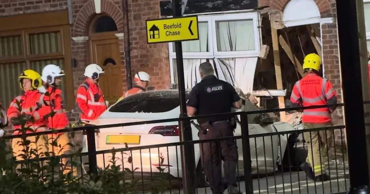 Tesla Crashes into House in Wigan, Two Injured
