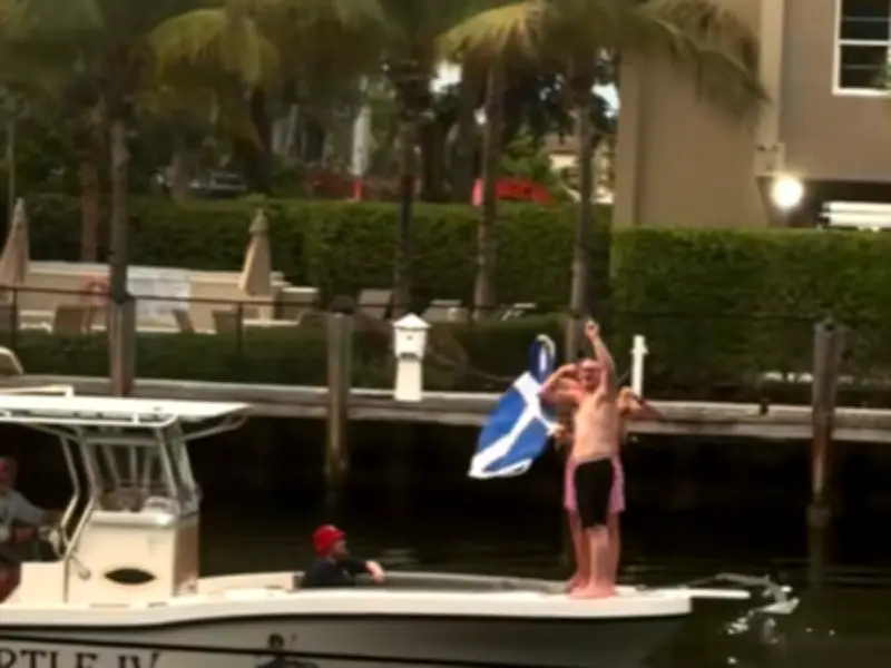 Tartan Army Fans Sail Florida Creek Playing Bagpipes and Flying Saltire