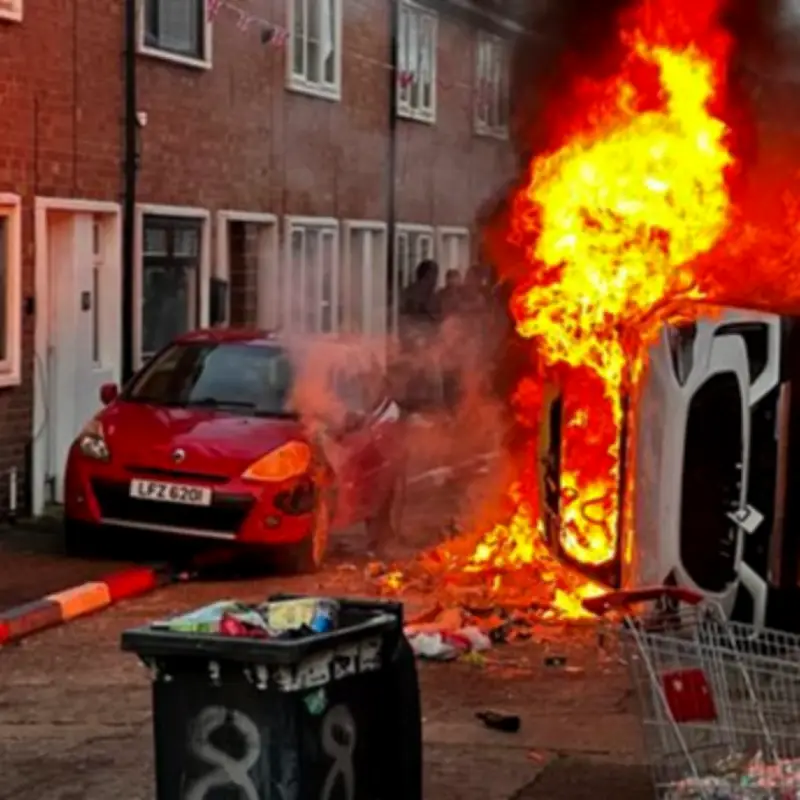 Violent Belfast Riots After Stabbing: Cars and Homes Torched