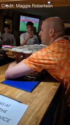 Dutch fan carries 26 pints of Tennent's in Fort William pub