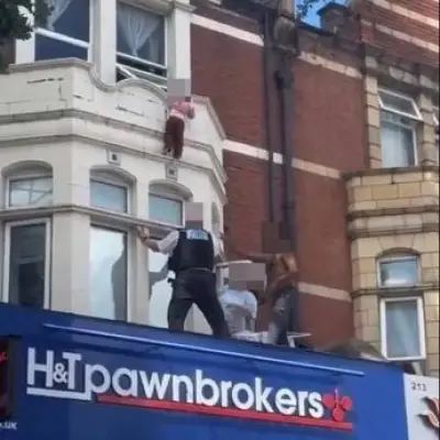 Hero catches toddler falling from ledge above East London street