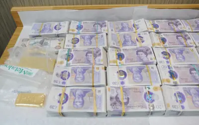 Moment police raid East London money store seizing £2.5m cash and gold