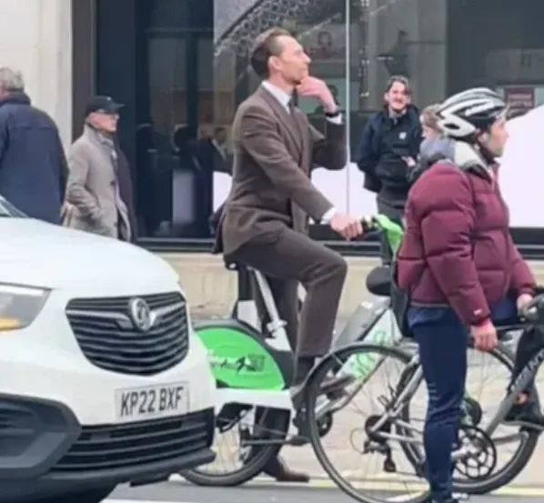Tom Hiddleston Spotted Riding Lime Bike in Suit Through Central London