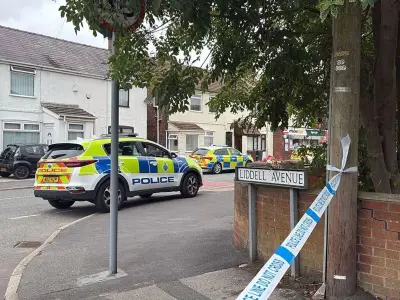 Man Shot in Neck on Merseyside Street; Armed Police Search Gardens